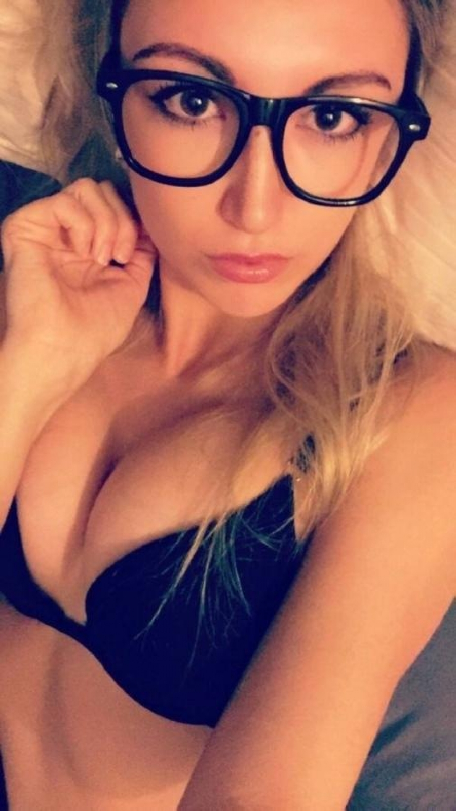 Hot sexy glasses blonde on the bed