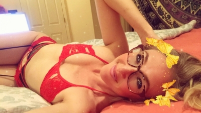 Beautiful brunette in red lingerie bikini bed selfie