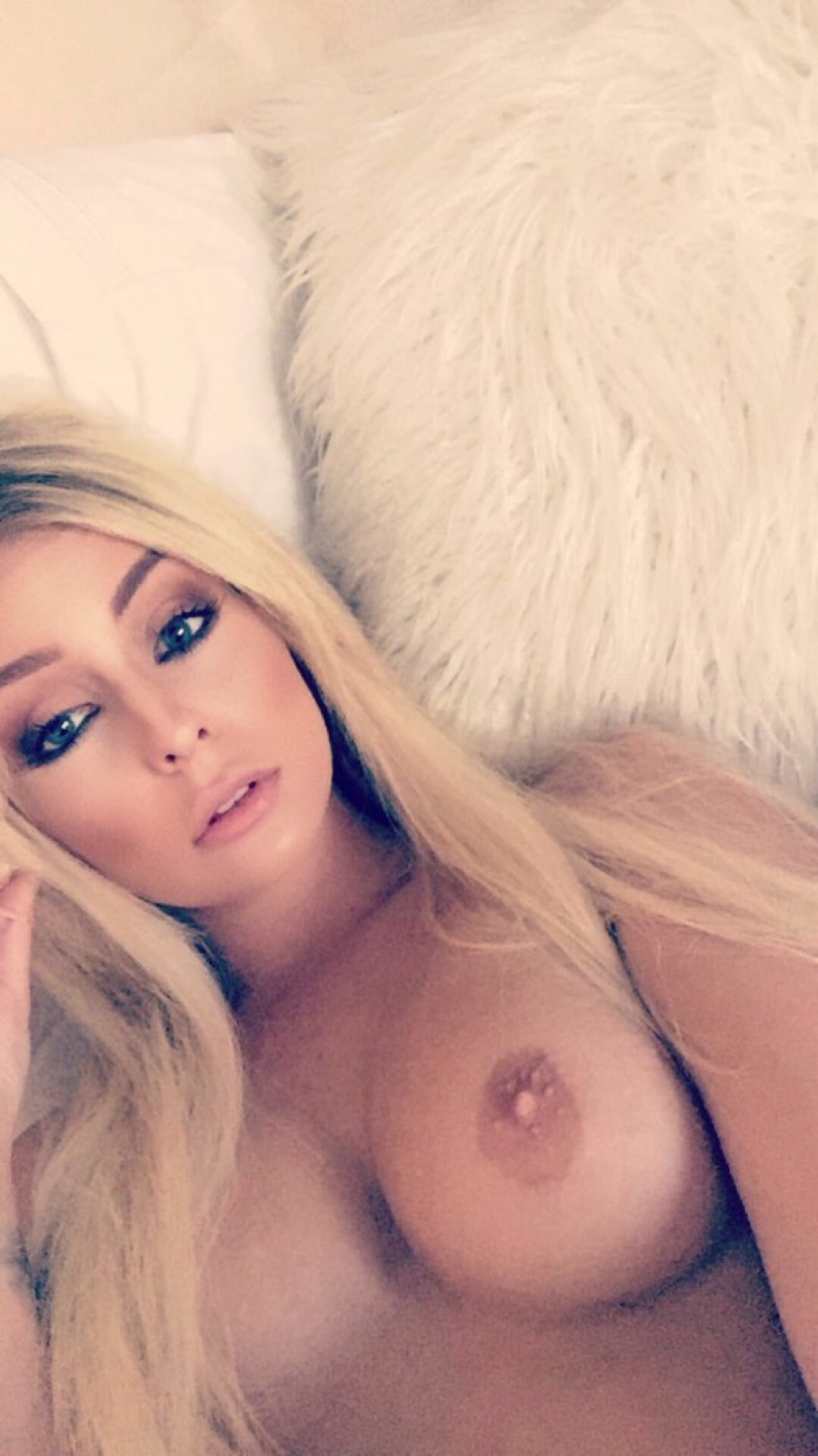 Hot blonde amateur topless selfie from bed